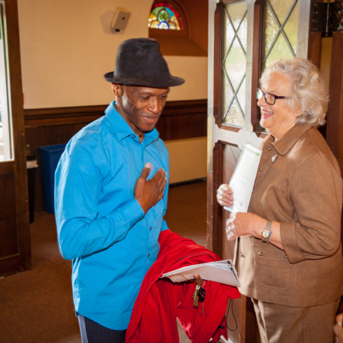 man walking through church doors